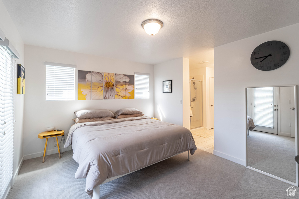 Bedroom featuring baseboards, carpet flooring, and a textured ceiling