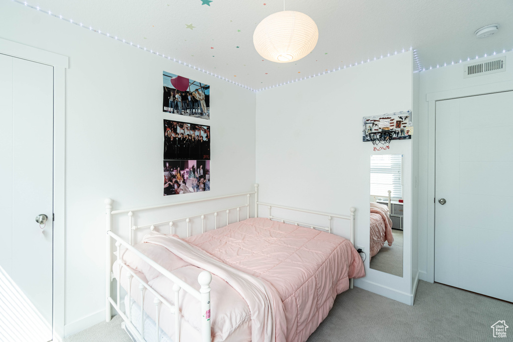 Bedroom featuring carpet, visible vents, and baseboards