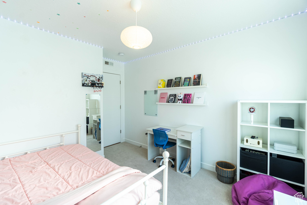 Bedroom with visible vents, light colored carpet, and baseboards