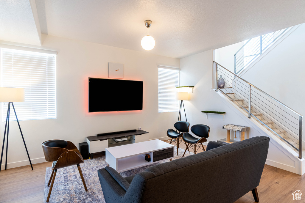 Living area with light wood-style floors and baseboards