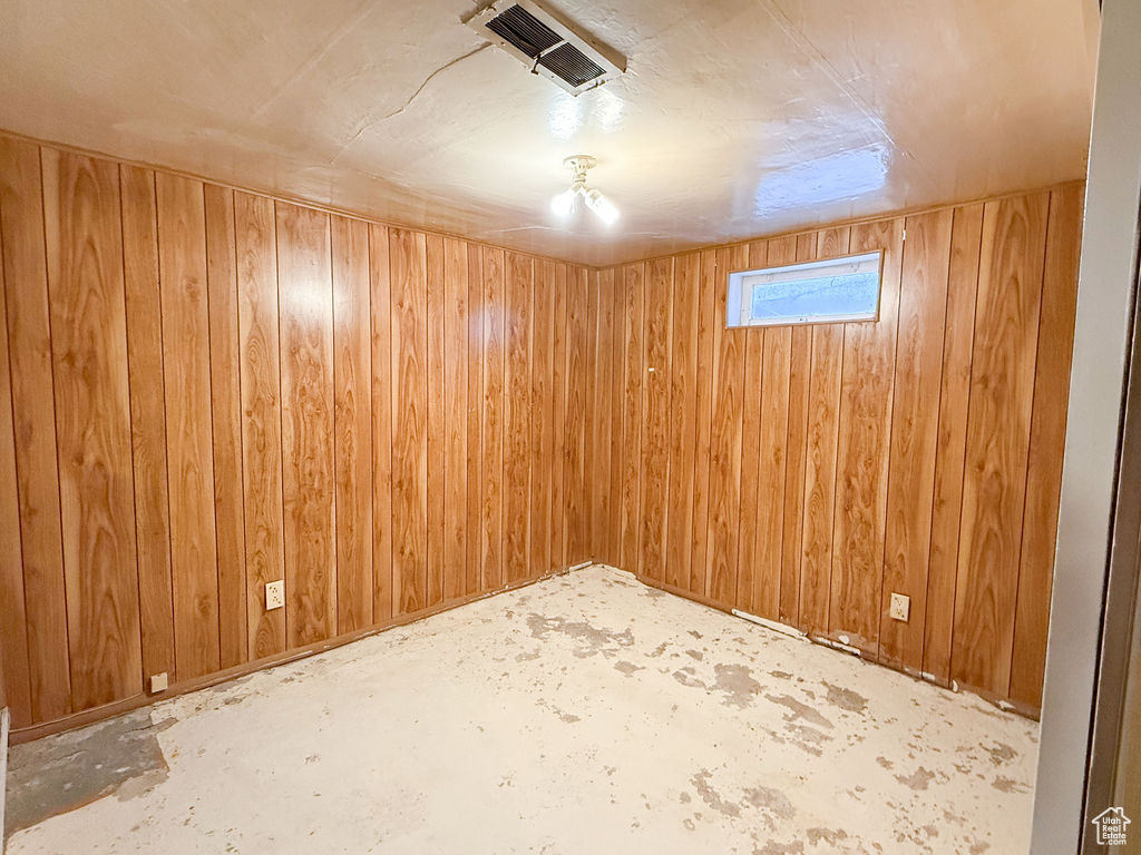 Basement with wood walls and visible vents