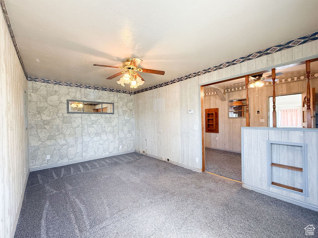 Spare room featuring carpet floors and ceiling fan