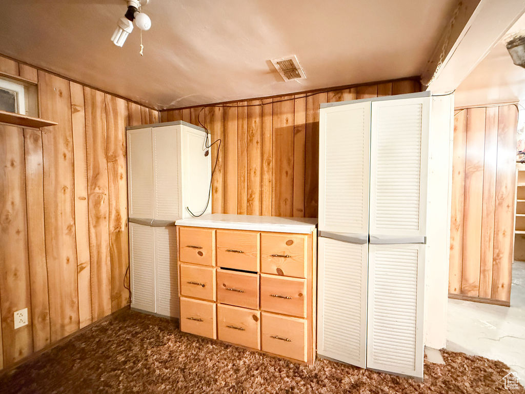 Interior space featuring wood walls and visible vents