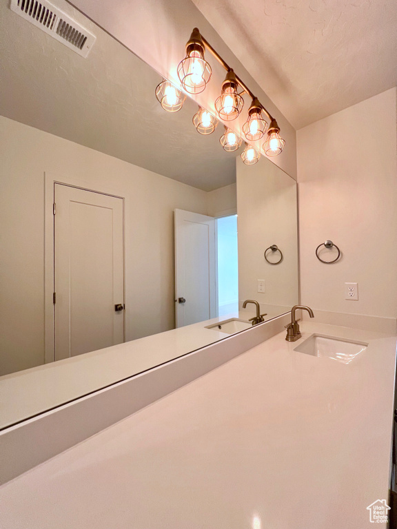 Bathroom with a sink and visible vents