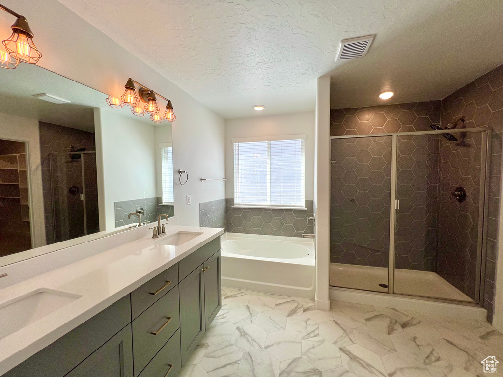 Full bath featuring a bath, visible vents, a sink, and a stall shower