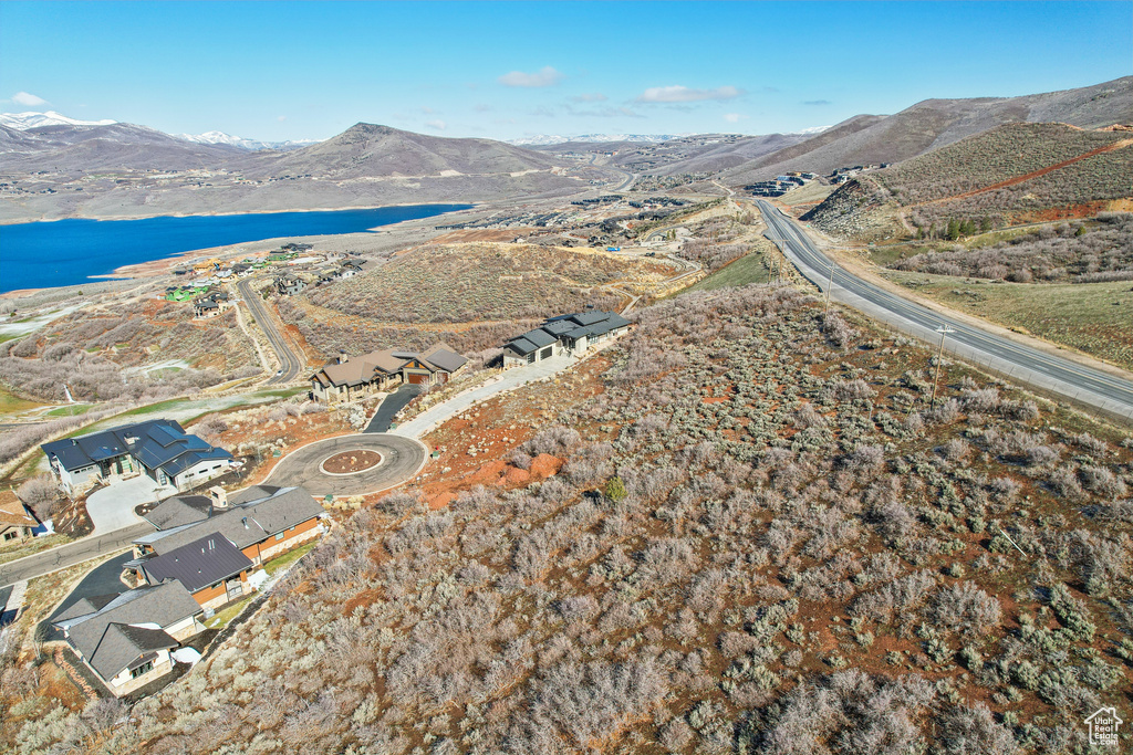 Drone / aerial view featuring a water and mountain view