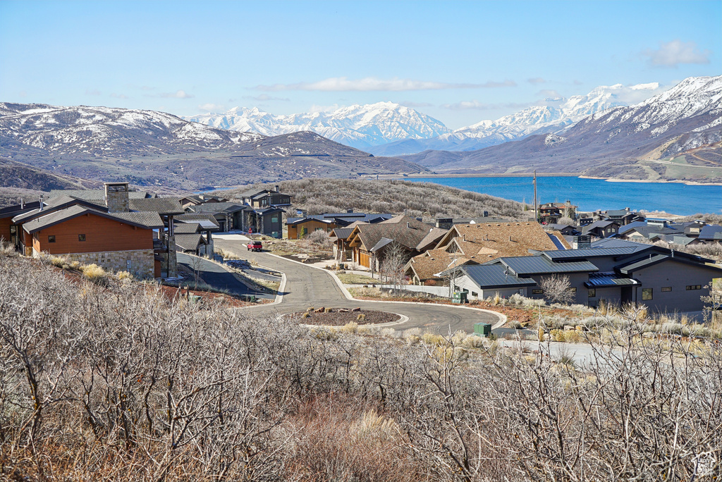 View of mountain feature with a residential view and a water view