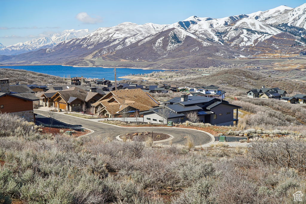 View of mountain feature with a water view and a residential view