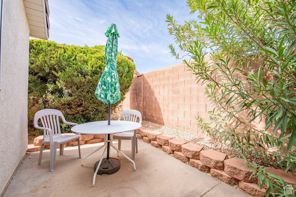 View of patio with outdoor dining area and fence private yard