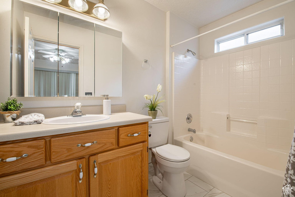 Bathroom featuring toilet, vanity, and shower / bath combination with curtain