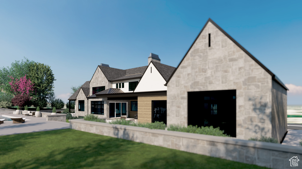 Back of property with a chimney, stone siding, a standing seam roof, a yard, and metal roof