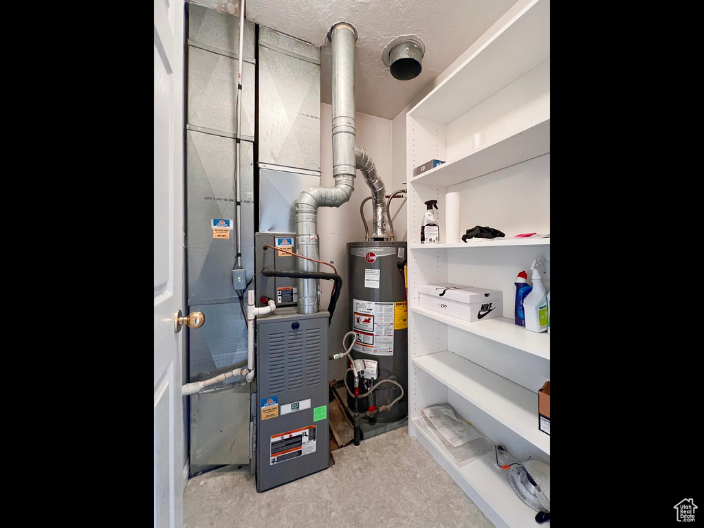 Utility room featuring water heater