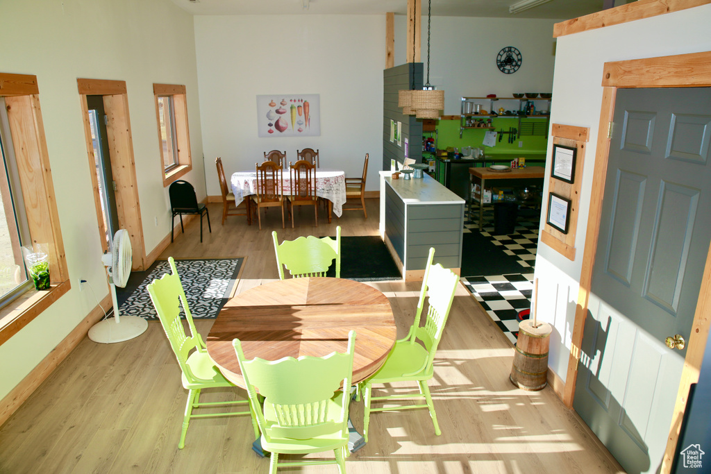 Dining space featuring light wood-style flooring and baseboards