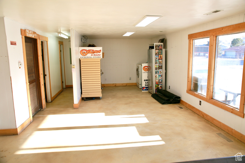 Interior space featuring baseboards, visible vents, and washer and clothes dryer