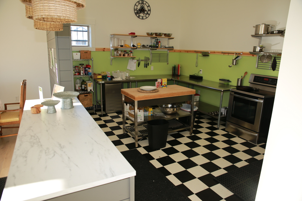 Kitchen featuring open shelves, refrigerator, stainless steel range with electric stovetop, and light floors