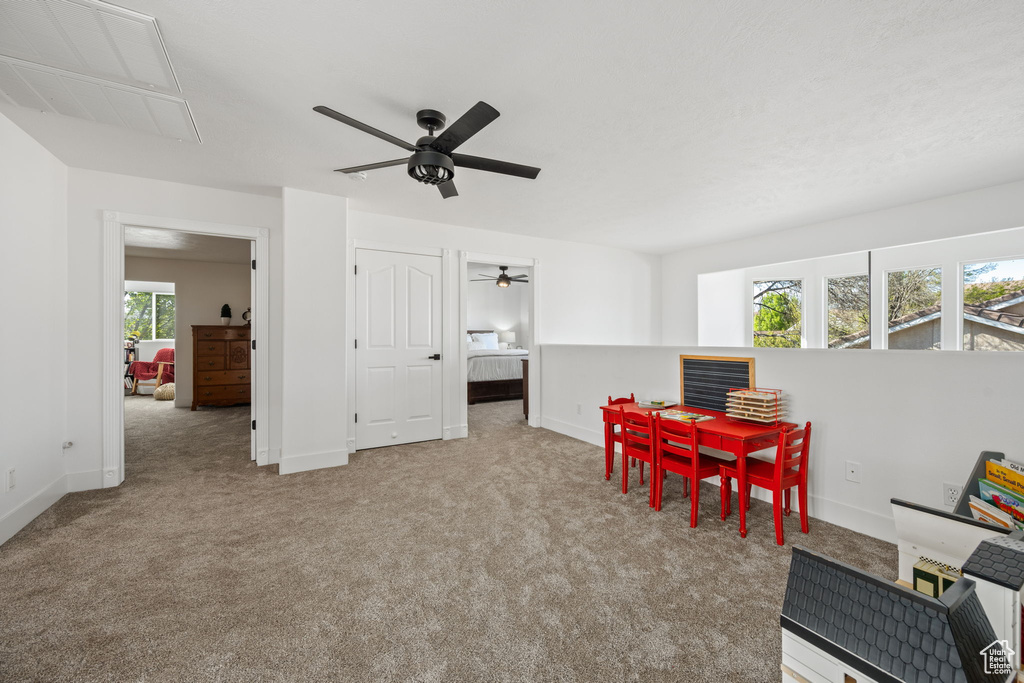 Playroom with baseboards, carpet flooring, and ceiling fan