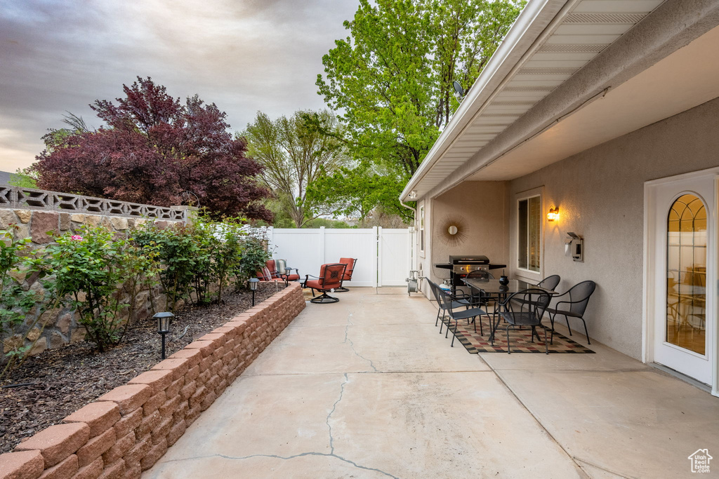 View of patio featuring a fenced backyard and outdoor dining space
