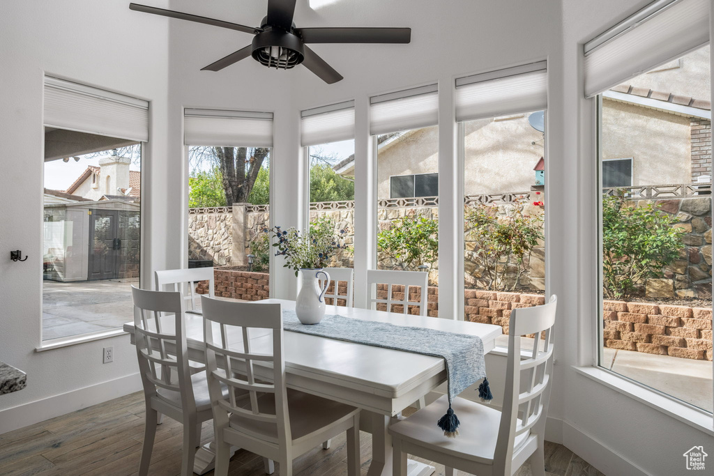 Sunroom with baseboards and wood finished floors