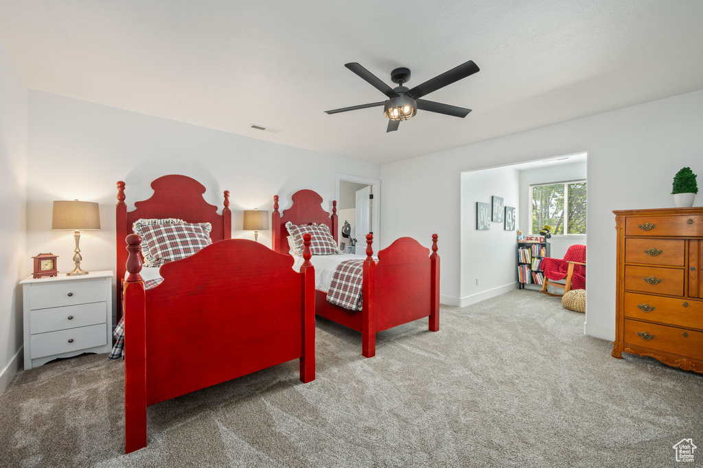 Carpeted bedroom featuring baseboards, ceiling fan, and visible vents
