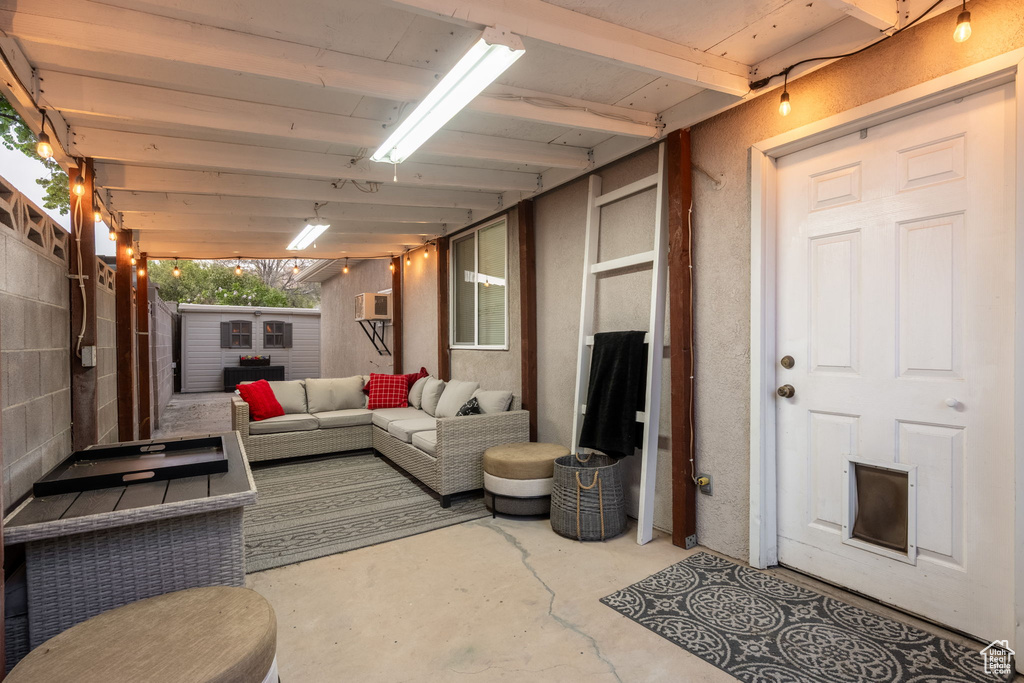 Interior space featuring a wall mounted AC and unfinished concrete floors