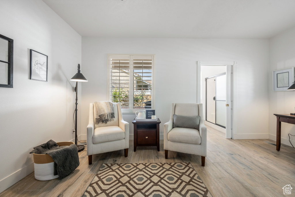 Sitting room with baseboards and wood finished floors