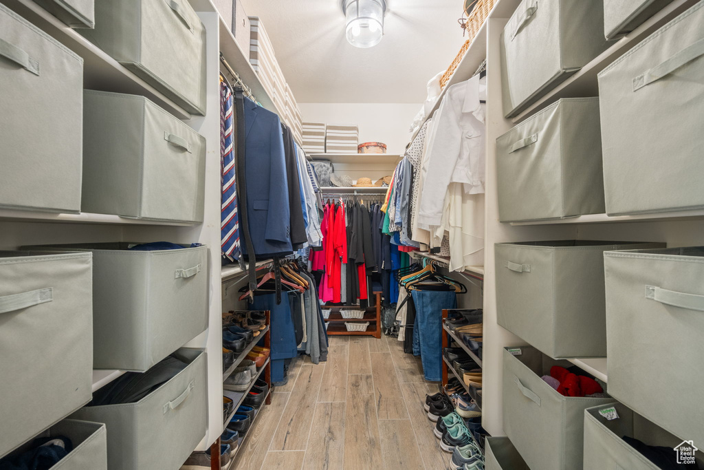 Walk in closet featuring wood finished floors