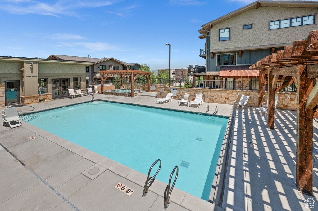 Community pool with a pergola, a patio area, and a community hot tub