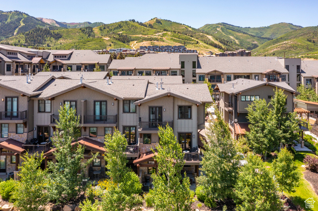 Aerial perspective of suburban area featuring a mountainous background