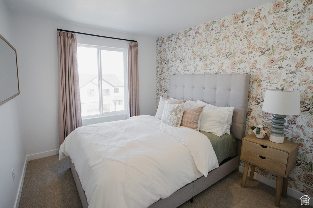 Bedroom with carpet, baseboards, and wallpapered walls