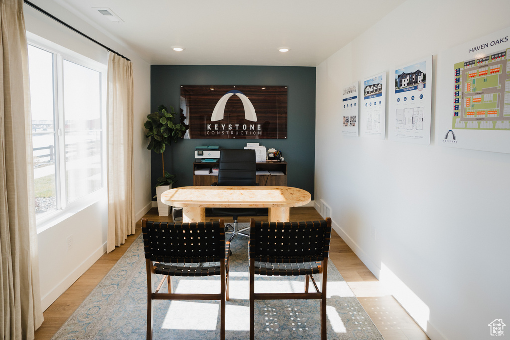 Dining room featuring light wood-style flooring, baseboards, and visible vents