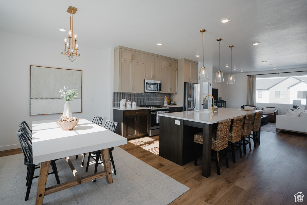 Dining room with recessed lighting, a notable chandelier, and light wood-style flooring