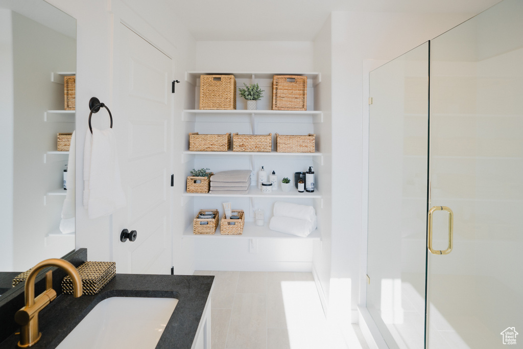 Full bath featuring a shower stall and vanity