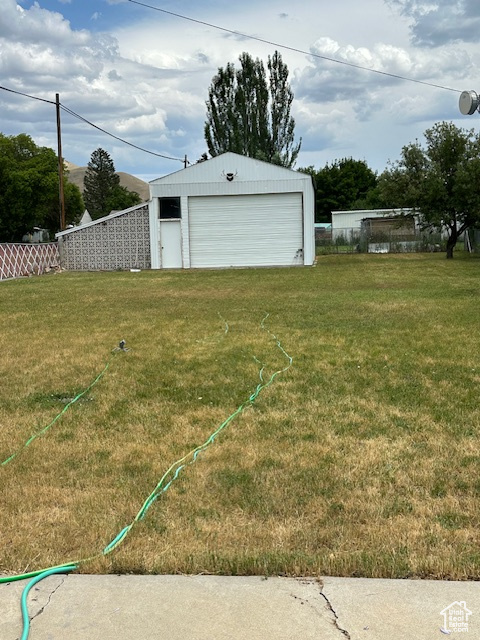 View of yard with an outdoor structure and a garage