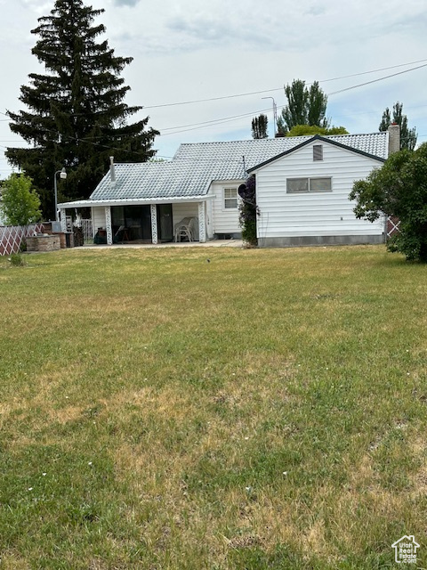 Back of property with a yard