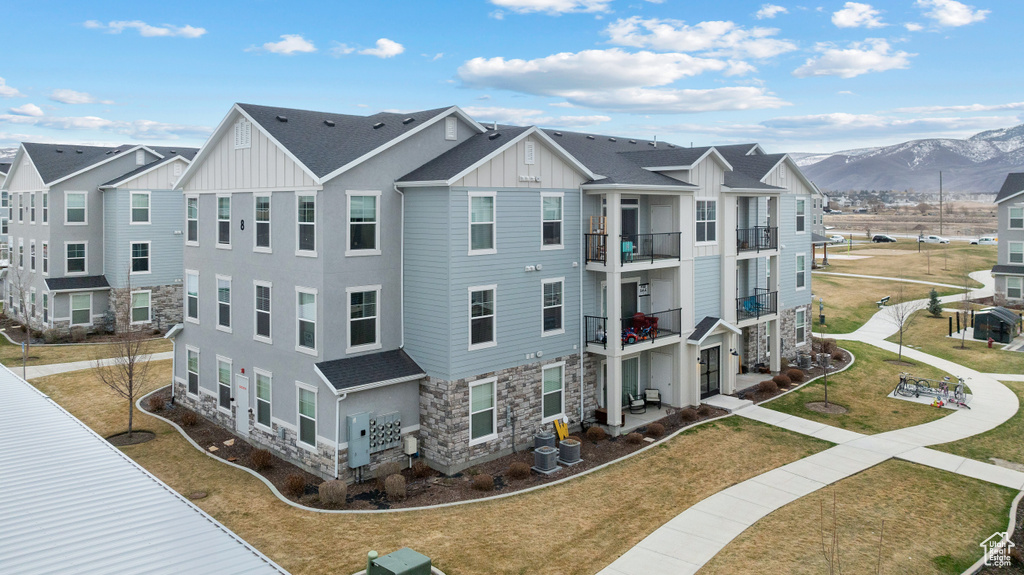 Exterior space with a residential view, central AC, and a mountain view