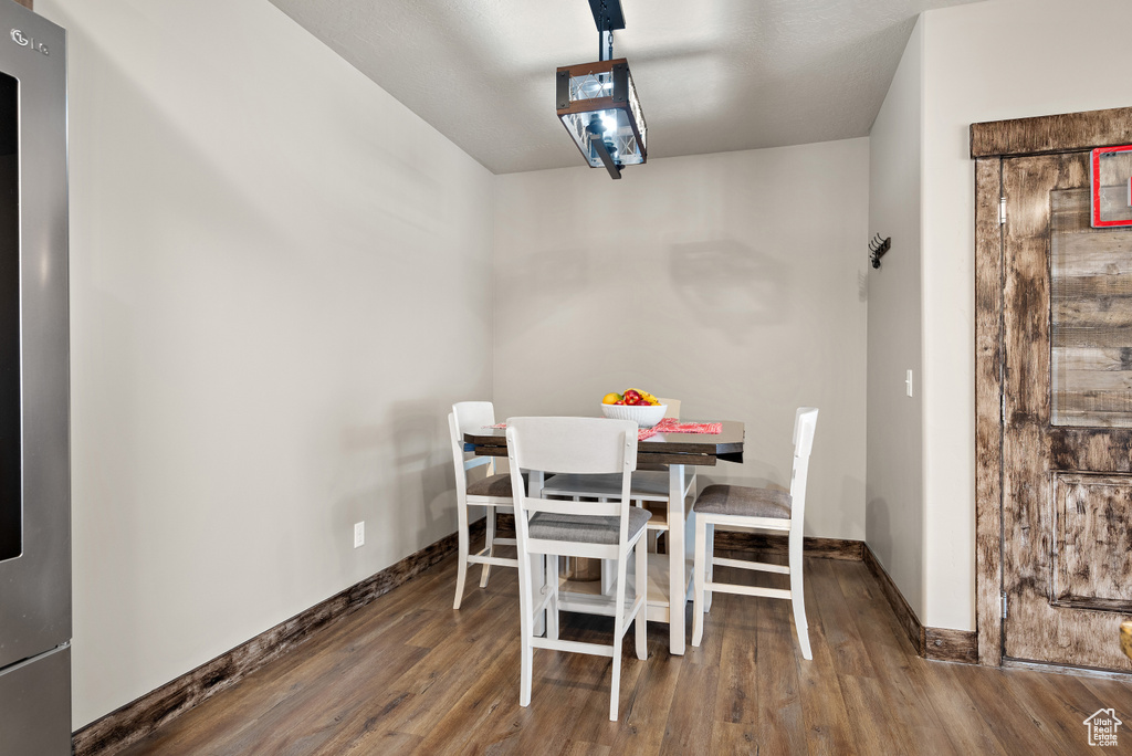 Dining room with wood finished floors and baseboards