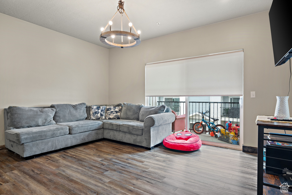 Living area featuring wood finished floors and a notable chandelier