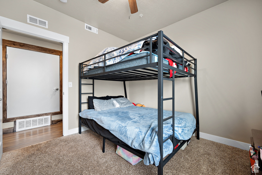 Carpeted bedroom featuring visible vents and baseboards
