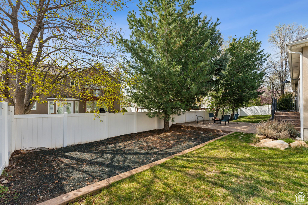 View of yard with a patio area and a fenced backyard