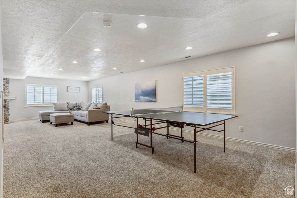 Recreation room featuring recessed lighting, carpet flooring, baseboards, and a textured ceiling