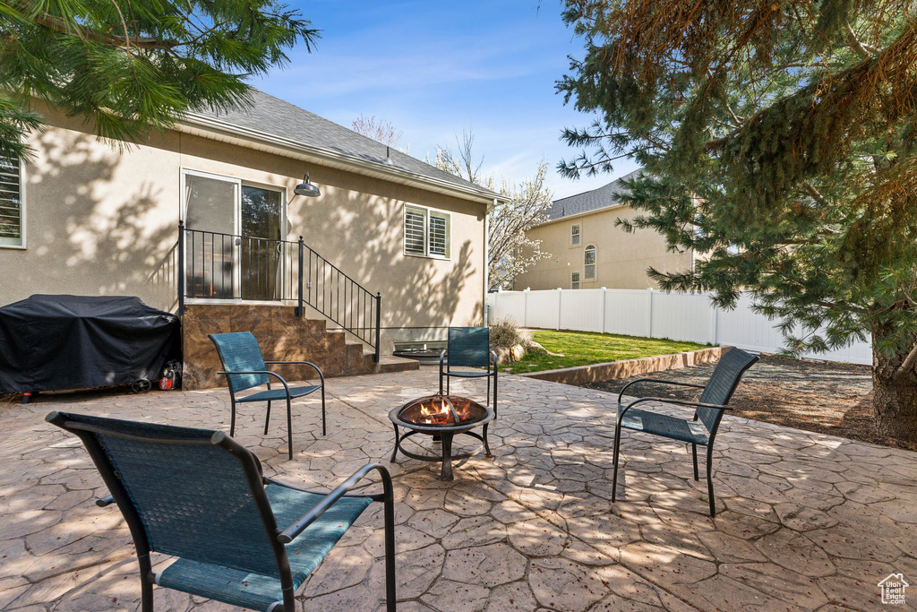 View of patio / terrace featuring grilling area, a fire pit, and fence