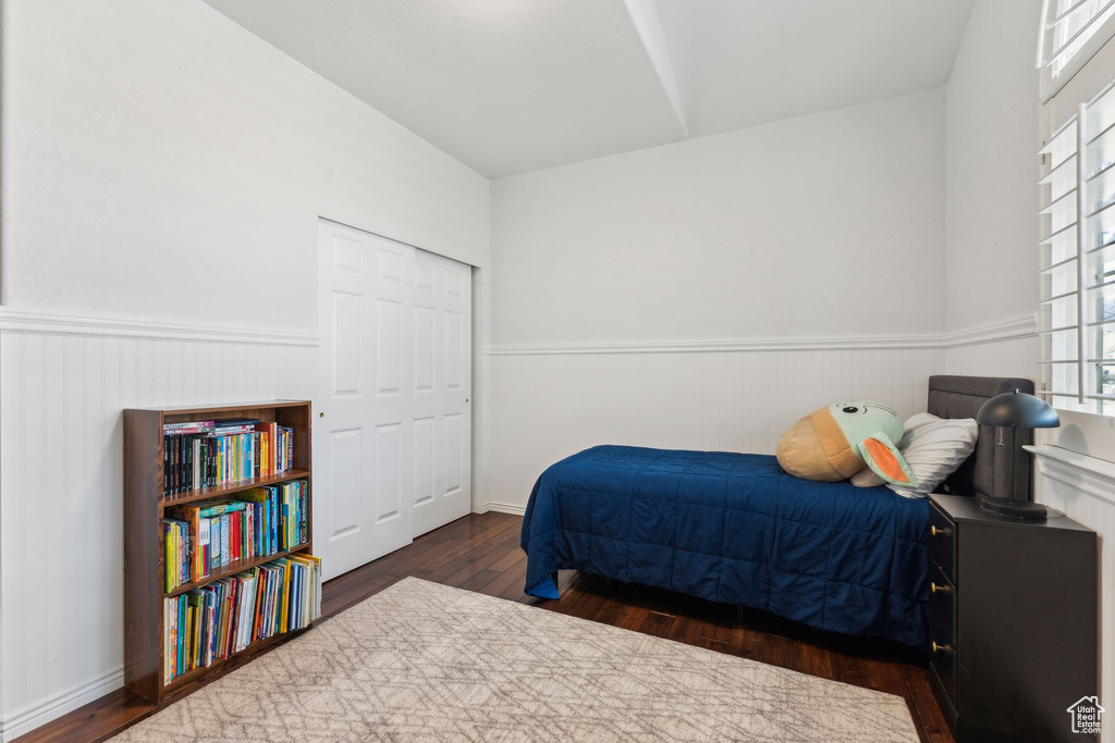 Bedroom featuring a wainscoted wall and wood finished floors