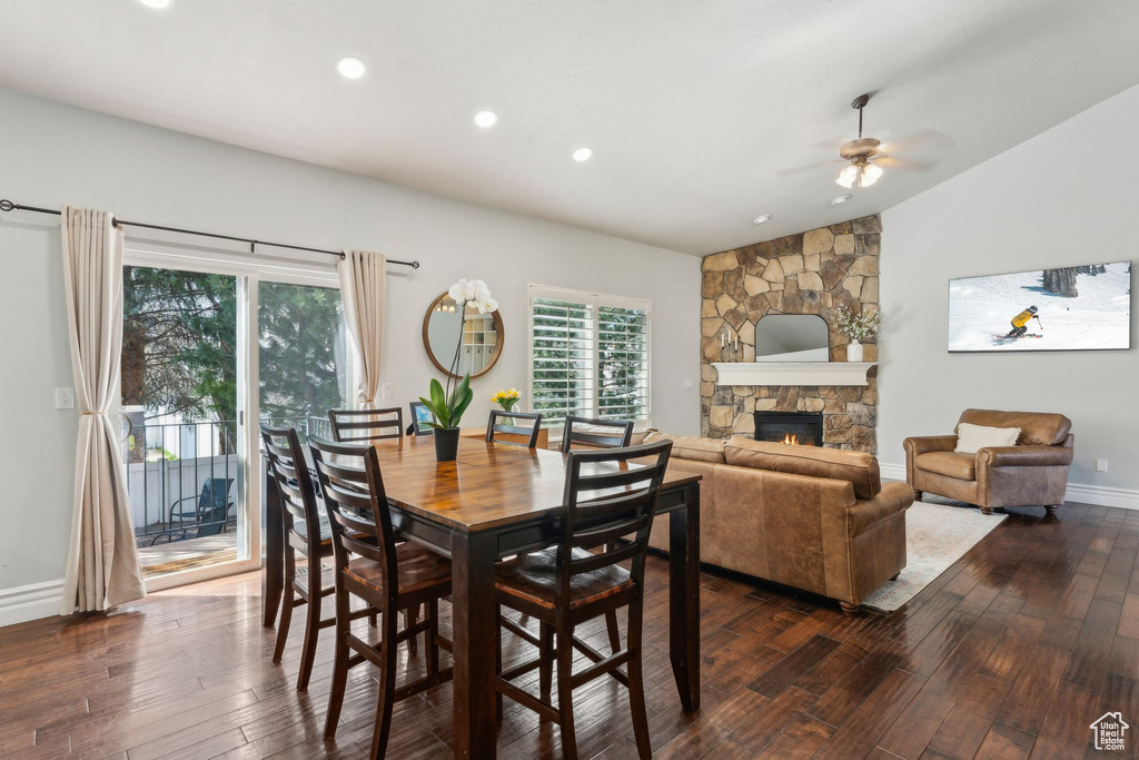Dining space featuring baseboards, a ceiling fan, a fireplace, recessed lighting, and dark wood-type flooring