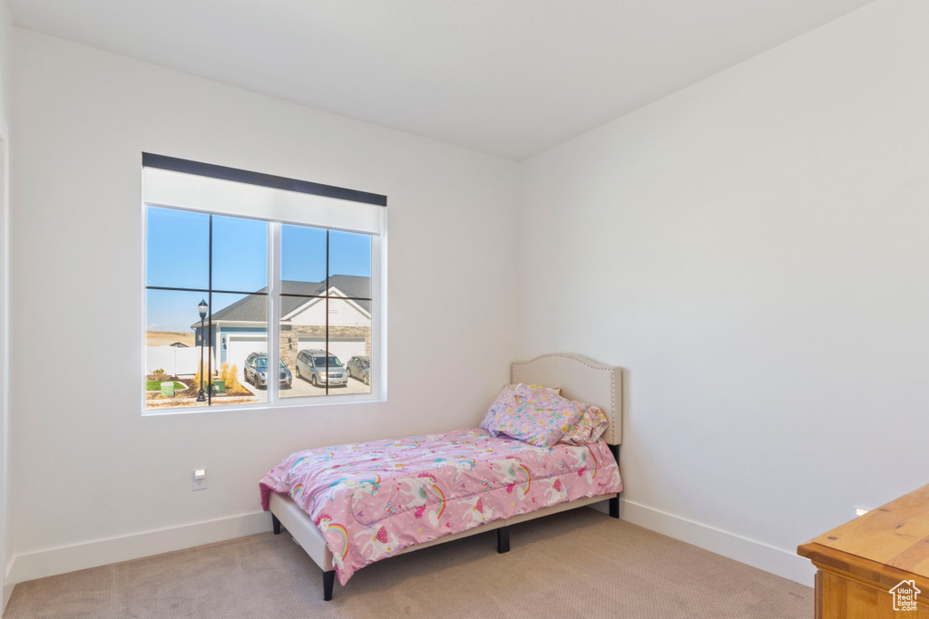 Carpeted bedroom with baseboards