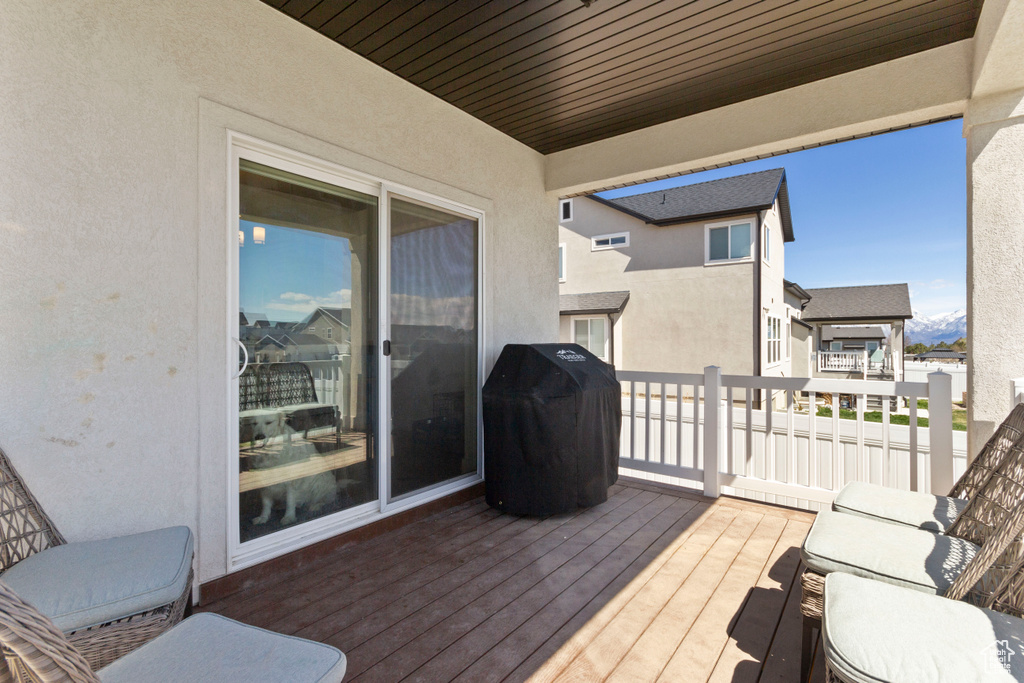 Wooden terrace with a residential view and grilling area