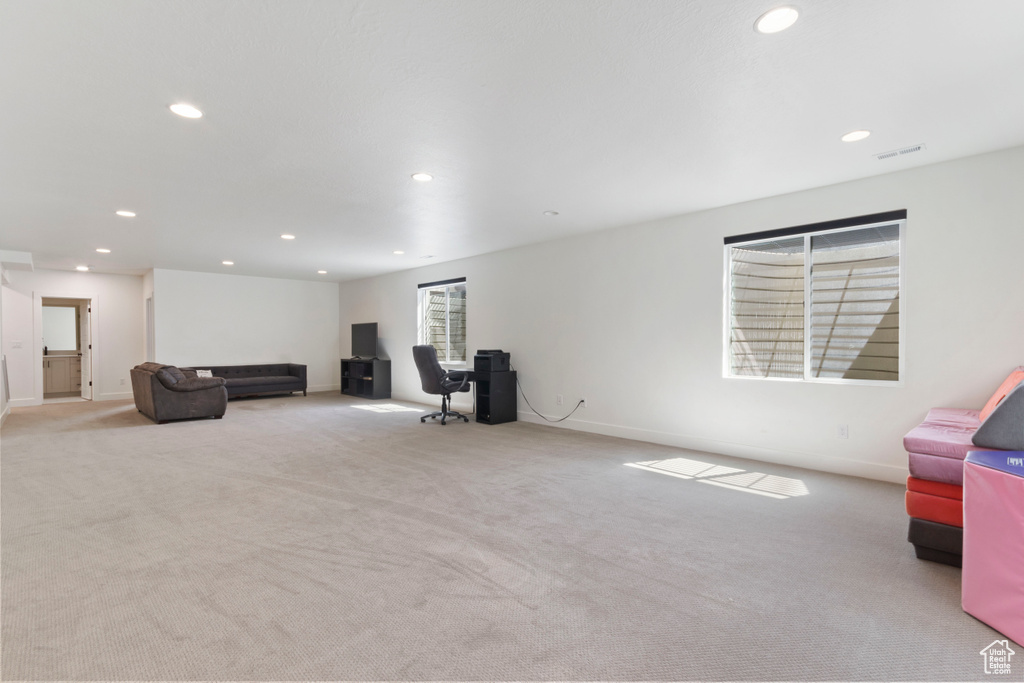 Living room with plenty of natural light, recessed lighting, carpet flooring, and visible vents