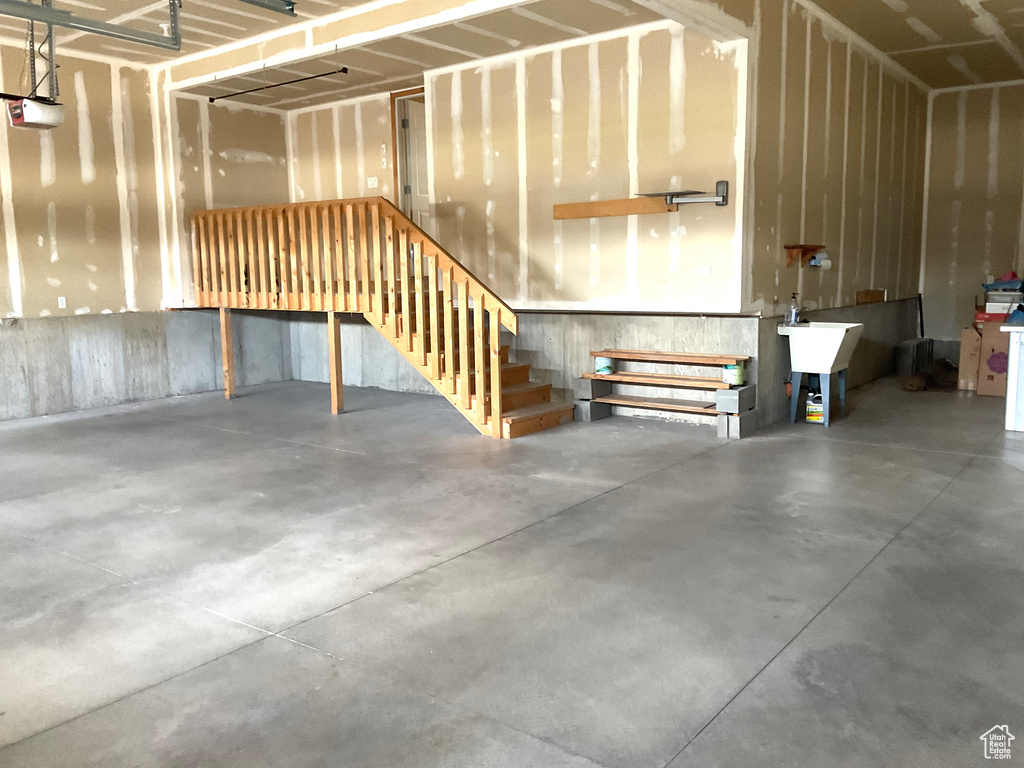 Garage featuring a garage door opener and a sink