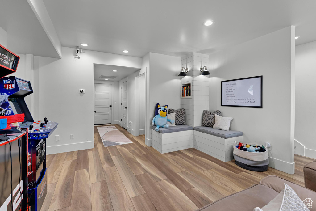 Interior space with baseboards, recessed lighting, and wood finished floors