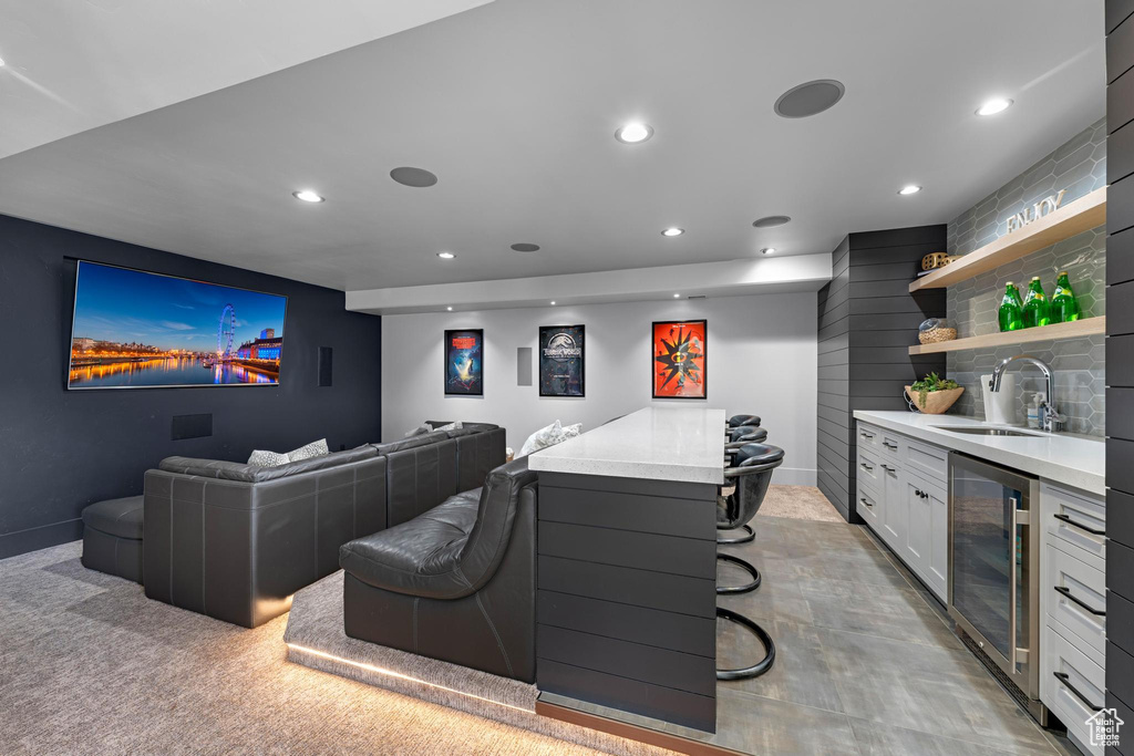 Cinema with a sink, recessed lighting, beverage cooler, and indoor wet bar