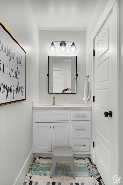 Bathroom with vanity and baseboards